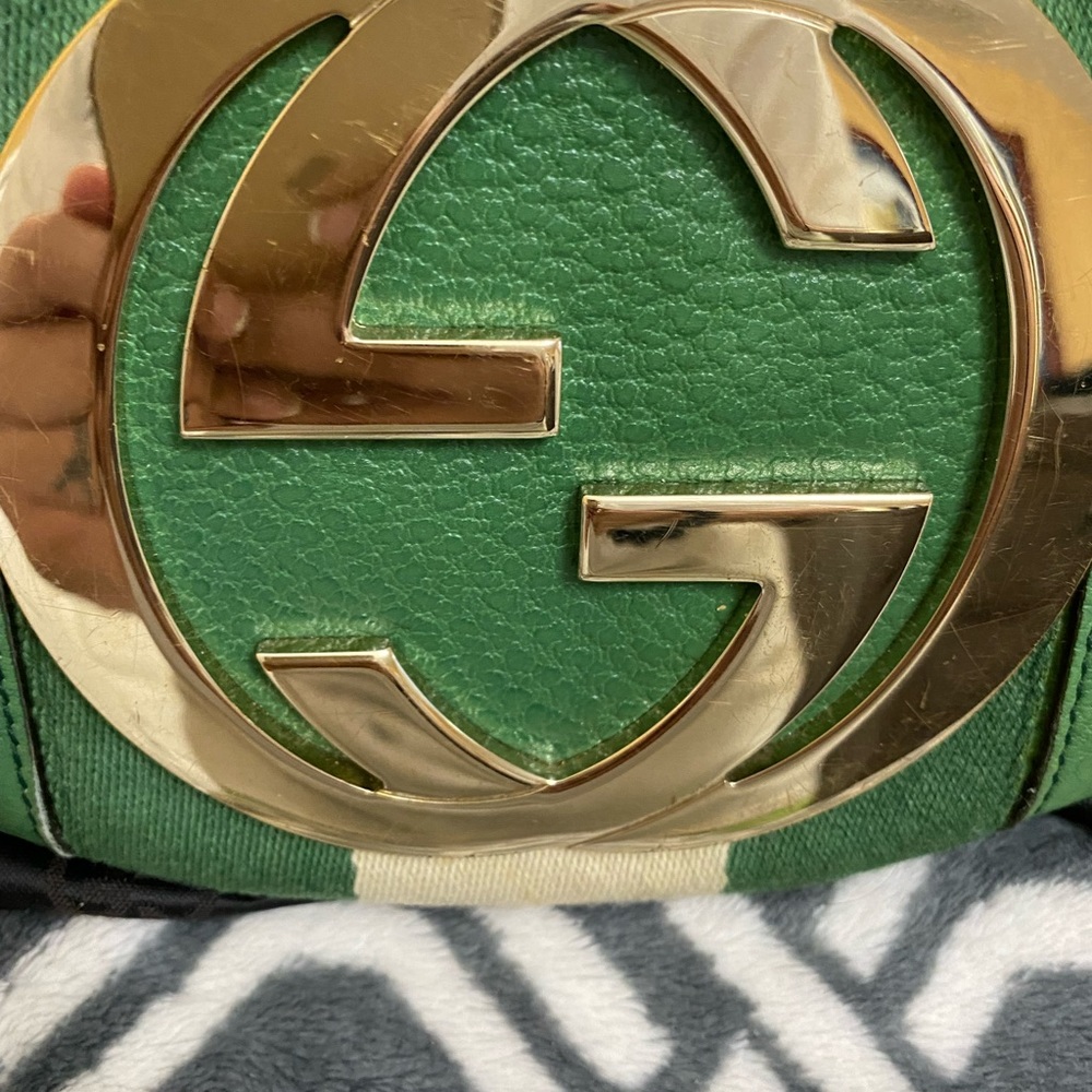 This is a authentic and vintage purse with hairline scratches on the gold emblem